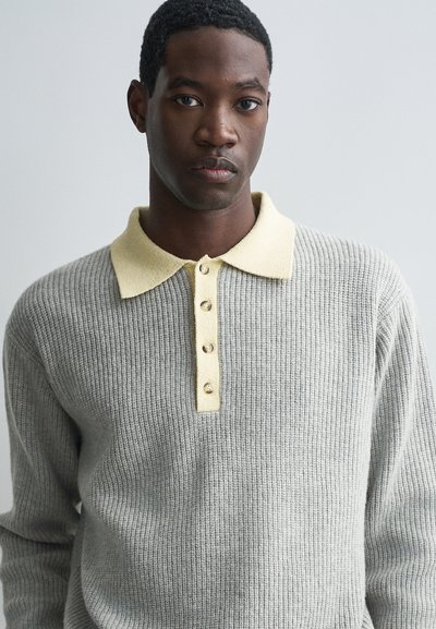 Halliseks hall ribased kampsun kerge kollase krae ja nööpide rida. Omab tekstuurset kudumist ja keskmist kaalu, sobib kihitamiseks.