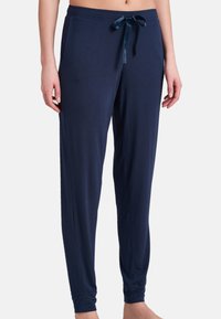 Mörkblå pyjamasbyxor i mjukt tyg, med dragstring i midjan, sidofickor och delt anklar med elastiska manschetter.