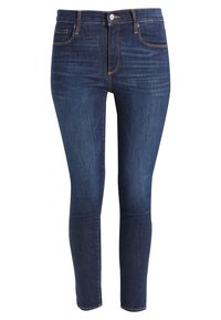 Vaqueros ajustados en denim azul oscuro, con una textura suave, sutiles marcas de desgaste, diseño de cinco bolsillos estándar y costuras contrastantes.
