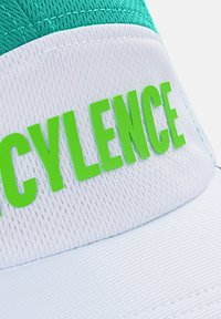 Cap with a white brim and teal top. Features bold green text "CYCLENCE." Made of breathable fabric with a textured finish.