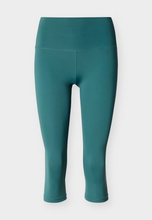 Τιρκουάζ κολάν ψηλόμεσο, κομμένο, με επίπεδες ραφές και λείο, εφαρμοστό σχέδιο, παρουσιασμένο πάνω σε απλό ανοιχτό φόντο.