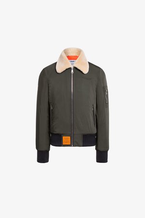 Donkergroene bomberjack met een nepbont kraag, ritssluiting, geribbelde manchetten en een oranje label aan de zoom. Glad materiaal, klassiek ontwerp.