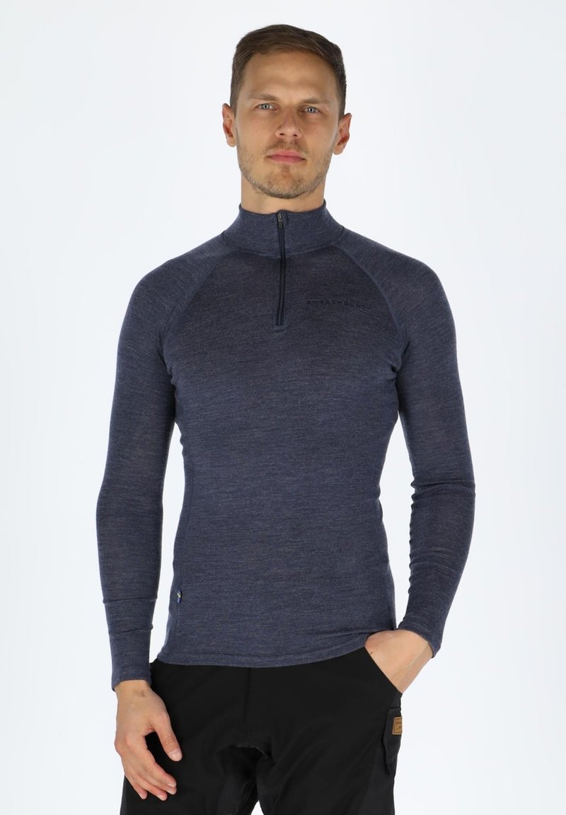Long-sleeve, navy blue top made of soft material with a half-zip collar and raglan sleeves, featuring a logo detail on the chest.