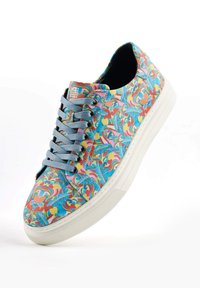 Colorful sneaker with a patterned fabric upper in blue, pink, and yellow. Features gray laces, a white rubber sole, and textured detailing.
