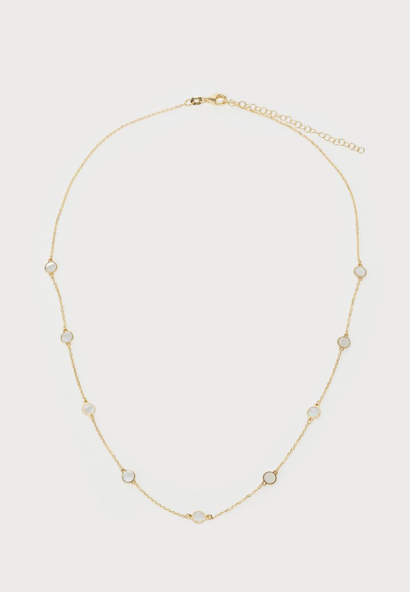 Kuldne kaelakee väikeste ümmarguste aktsentidega, millel on valged, poolläbipaistvad kivid, ühtlaselt jaotatuna kogu pikkuses. Krabi tüüpi kinnitus.