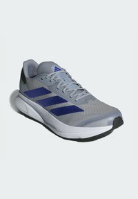 Men's running shoe in gray mesh with blue stripes. Features a textured upper, padded collar, and a white midsole with a black outsole.