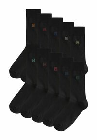 Calzini neri in cotone con bordo a coste. Ognuno presenta un piccolo logo "N" colorato in diverse tonalità sul lato superiore. Set di dieci paia.