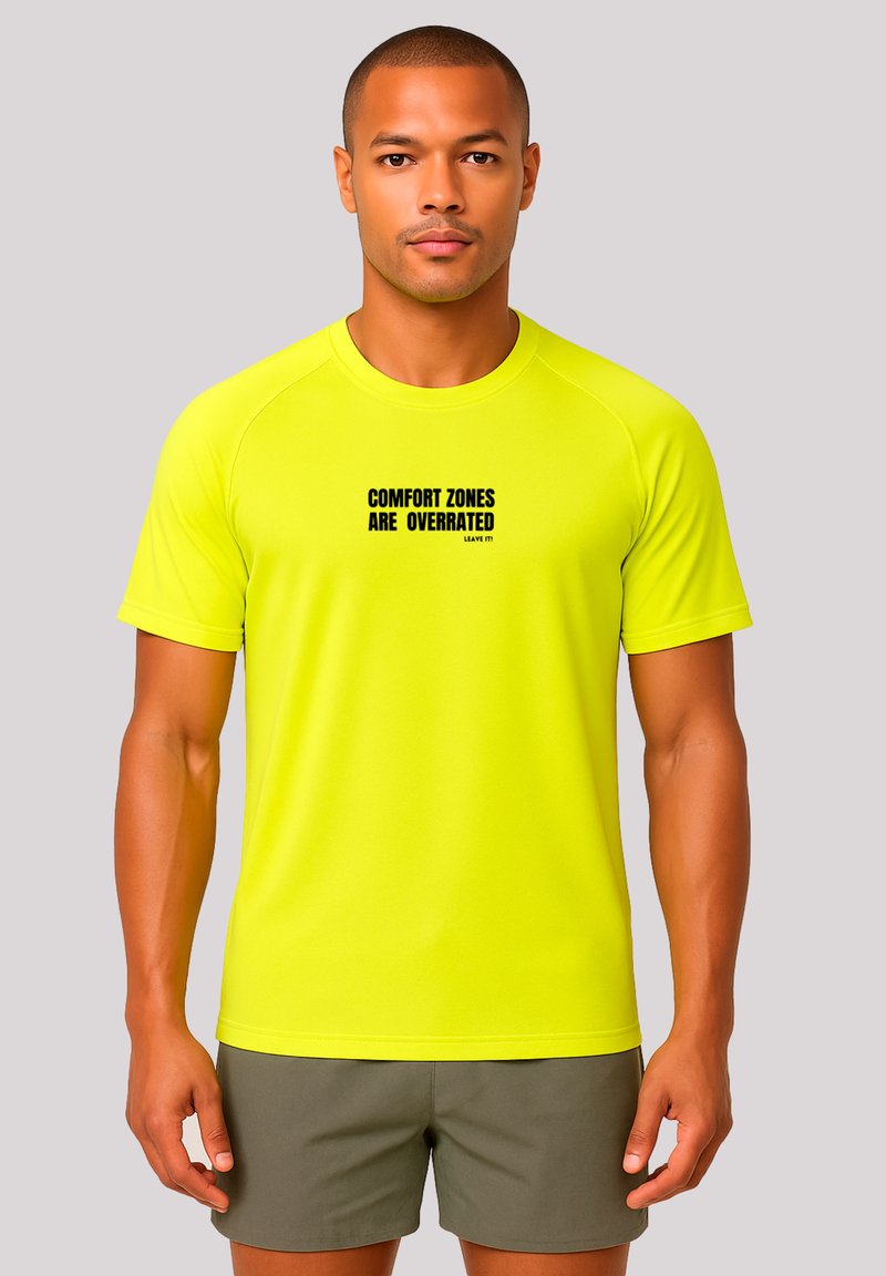 Fluorescent yellow athletic shirt with short sleeves, featuring black text "COMFORT ZONES ARE OVERRATED" on the front, lightweight fabric.