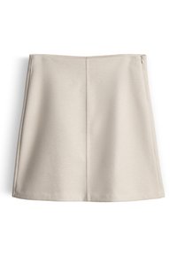 Mini-jupe beige avec une texture lisse, un design structuré, et une fermeture éclair latérale discrète. Présente une silhouette épurée et simple sans motifs.