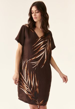 Brown linen dress with short sleeves, V-neck, featuring printed beige and gold palm leaves, smooth texture, knee-length cut.