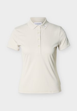 Kremfarvet polo i kortærmet model med fire knapper, krave og subtilt logo på venstre krave og højre ærme.
