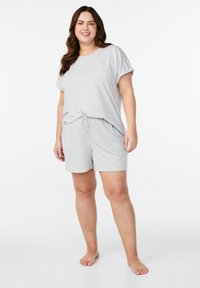 Gray, striped loungewear set. Loose-fitting short-sleeve top with a pocket. Elastic waist shorts with side pockets. Soft cotton blend fabric.