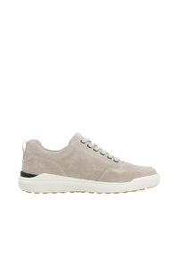 Suede sneakers in light beige with a rounded toe, gray laces, white midsole, and a black accent at the heel. Textured surface with a pull tab.