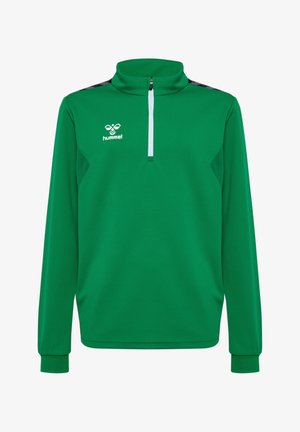 Hauts de sport verts avec des zips, associés à des pantalons noirs. Les deux vêtements ont une texture lisse et des accents contrastants. Les chaussures varient en couleur.
