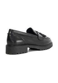 Black leather loafer with a flat rubber sole, tassel detail, and stitching accents. Sleek rounded shape and polished finish.