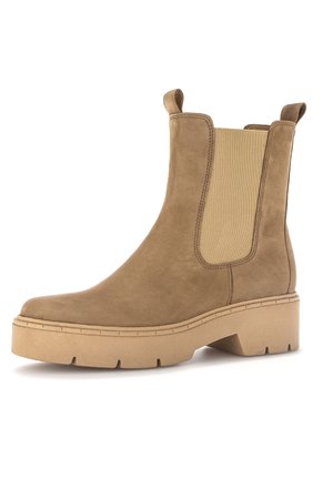 Brown suede ankle boot with elastic side panels, rounded toe, and chunky beige sole. Features stitching details and pull tabs for easy wear.