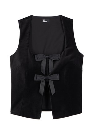 Musta hihaton samettivesti, jossa syvä suorakaiteen muotoinen pääntie ja kaksi satiininauhabrodiiria edessä, merkkinä "The Kooples."