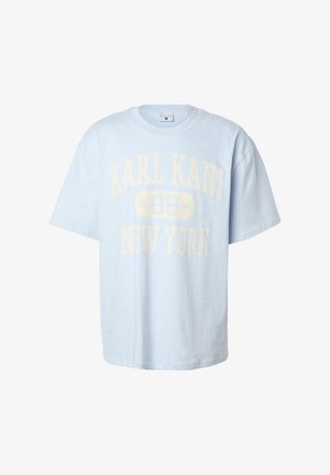 T-shirt a maniche corte di colore azzurro chiaro con vestibilità oversize, con testo sbiadito giallo "KARL KANI 89 NEW YORK" sul davanti.