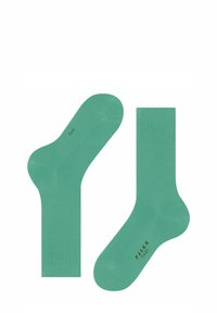 Grüne Baumwollsocken mit Rippbündchen. Verfügt über einen nahtlosen Zehenbereich und einen aufgedruckten Markennamen auf der Sohle. Leicht und mit glatter Textur.