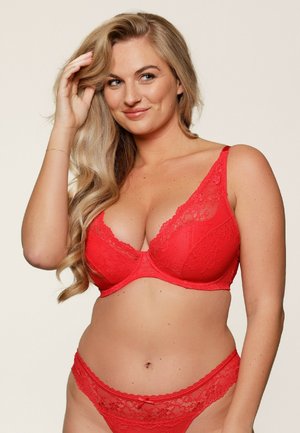 Red lace bra with a smooth underwire design, featuring floral patterns and wide straps. Paired with matching lace thong.
