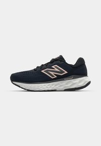 Navy running shoe with a mesh upper, pink accents, and a textured white sole. Features the "Fresh Foam" logo on the side.