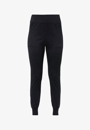 Pantalones deportivos negros hechos de tela elástica, con una cinturilla ancha, dos bolsillos frontales y puños ajustados en los tobillos.