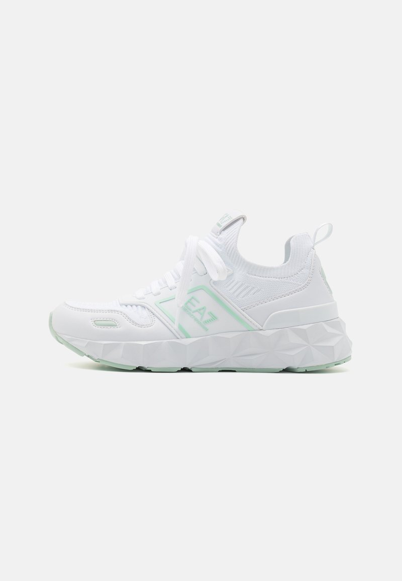White athletic sneaker with textured sole, knit ankle collar, lace-up front, and light green accents and branding on side and tongue.