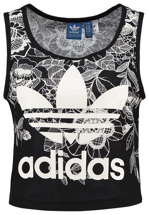 Czarny bezrękawnik Adidas z dużym białym logo trefoil i kwiatowym wzorem koronkowym w tle. Metki z rozmiarem widoczne wewnątrz kołnierza.