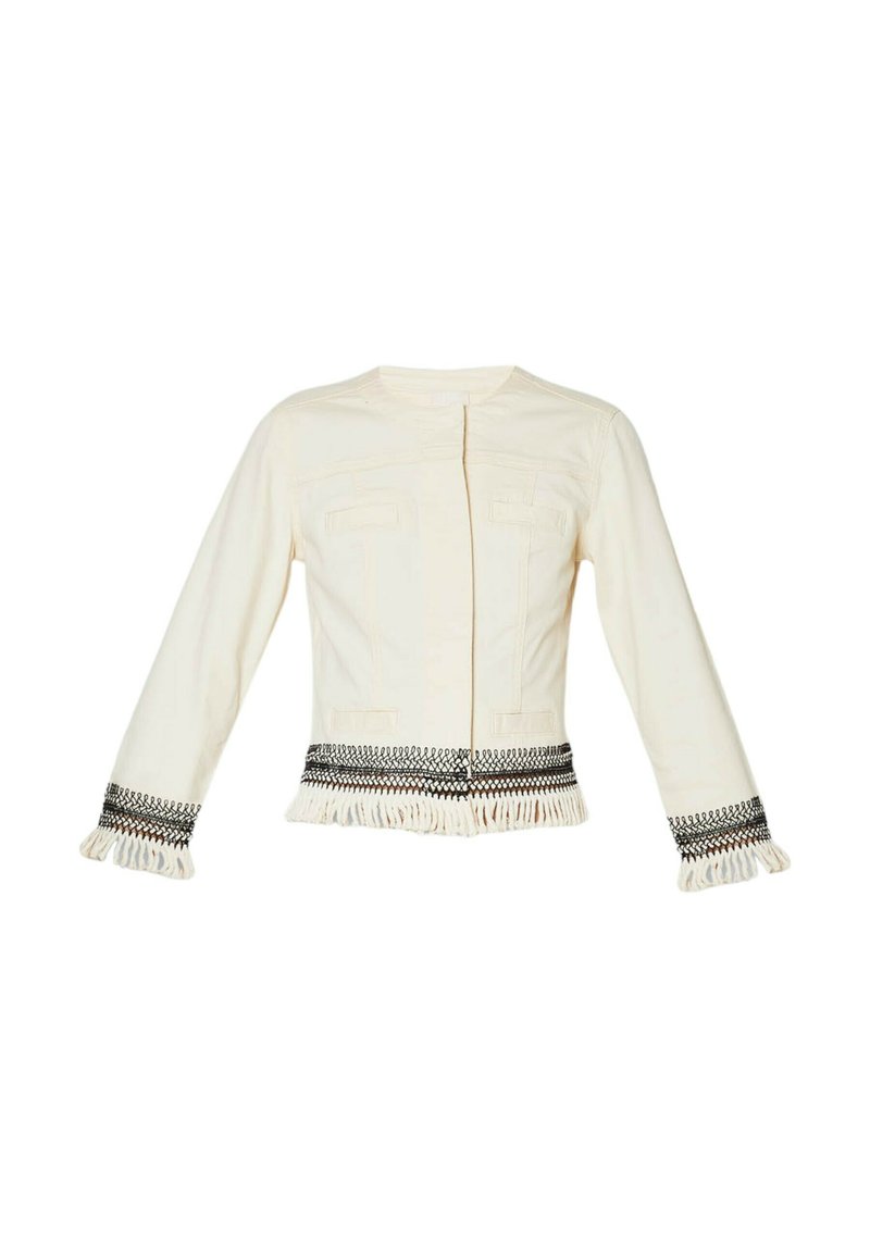 Veste couleur crème avec des manches longues, des poches avant et une bordure décorative avec des franges et des détails noirs au bord et aux poignets.