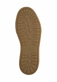 Sole of a brown Blackstone shoe with a patterned tread featuring crosses and geometric shapes on a white background.