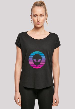 Black short-sleeve t-shirt with a round, colorful gradient alien graphic. Soft texture, relaxed fit, curved hem, and rolled sleeves.