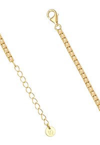 Zelta tonēta aproce ar savienotām ķēdēm un rakstainu skaidru, mirdzošu akmeņu daļu. Tajā ir iemontēta homāra sprādze un logotipa tagi.