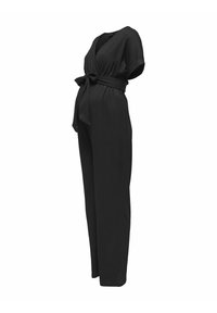 Mono negro con diseño cruzado, mangas cortas, cintura ajustada con lazo y corte holgado. Fabricado en tejido ligero con superficie texturizada.