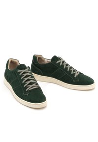 Zielone zamszowe sneakersy mają niską cholewkę, szare sznurowadła oraz teksturowaną powierzchnię z białą gumową podeszwą.