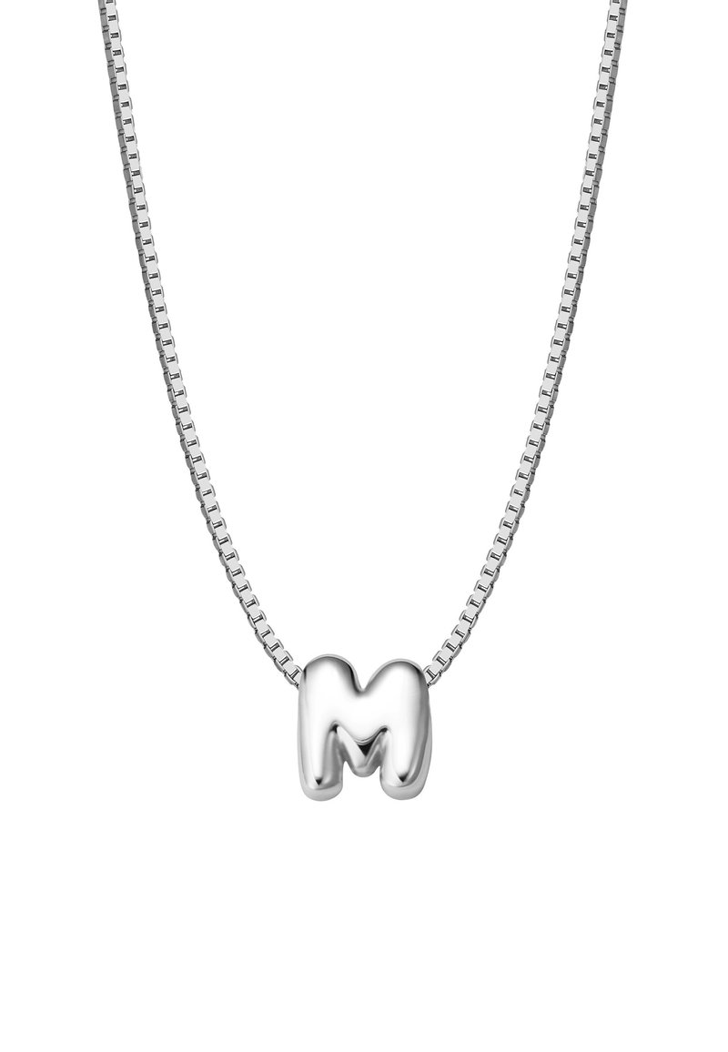 Srebrna ogrlica s lancem koja se sastoji od masivnog, sjajnog privjeska u obliku slova "M", s glatkim zavojima i reflektirajućom površinom.