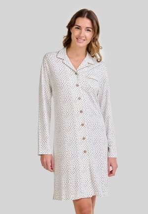 Camisón de algodón ligero, con botones en la parte delantera, mangas largas y un patrón de lunares en azul y negro sobre un fondo blanco.