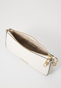 White leather clutch with gold hardware, smooth texture, zip closure, and a patterned interior. Features embossed brand label inside.