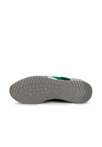 Zapatilla verde y blanca con una suela de goma texturizada, patrón de banda de rodadura circular y la marca "Munich desde 1939" en la entresuela.