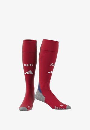 Rote Sportsocken mit grauem Zeh, versehen mit weißen Logos "AFC" und drei Streifen. Hoher, gerippter Schaft für einen sicheren Sitz. Weiches, elastisches Material.