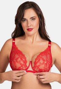 Roter Spitzen-BH mit transparenten Cups, dekorativem Blumenmuster, verstellbaren Trägern und tiefem Ausschnitt. Glattes Material und kontrastierende Akzente.