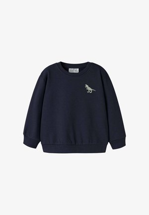 Tumesinine dressipluus pikkade varrukatega, ümar kaelusega, soonikkoes mansettidega ja vasakul rinnal tikitud dinosauruse kujundusega. Pehme materjal.