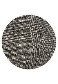 Texture de tissu pied-de-poule noir et blanc avec un motif tissé de petits carreaux répétitifs dans un cadre circulaire.