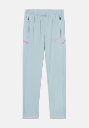 Pantaloni sportivi azzurri chiari con vita elastica, tasche laterali con zip e dettagli rosa sulle tasche e sul logo. Tessuto liscio con una leggera lucentezza.