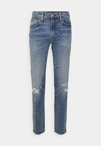 Ljusblå denimjeans med slim fit, med slitna områden, färgstänk och en klassisk femficksdesign.