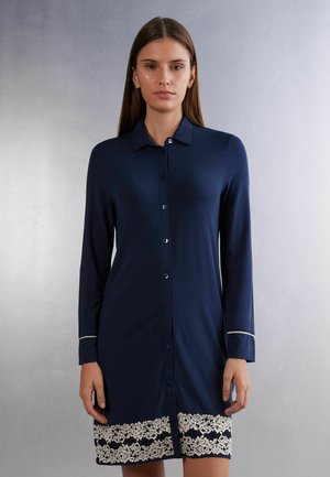 Navy blue button-up dress with long sleeves, featuring a white lace trim at the hem and a classic collar design. Soft fabric texture.