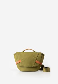 Olive green crossbody bag with tan leather accents, top handle, and adjustable shoulder strap on a white background.