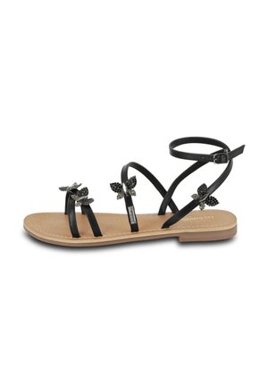 Sandali neri piatti con tre sottili cinturini e cinturino alla caviglia. Decorati con dettagli a farfalla neri. Sottopiede in pelle liscia color tan. Design semplice.
