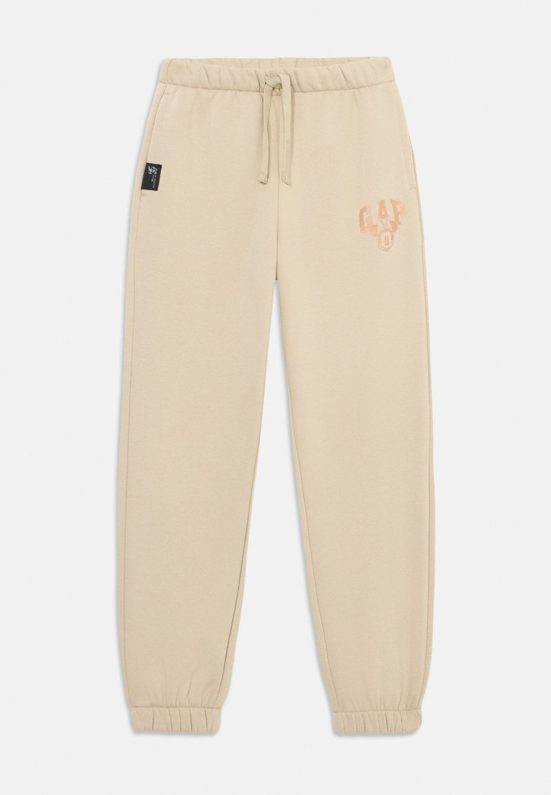 Beige joggebukser med snor i livet, elastiske mansjetter, sidelommer og et falmet GAP-logo med Minnie Mouse på venstre lår.