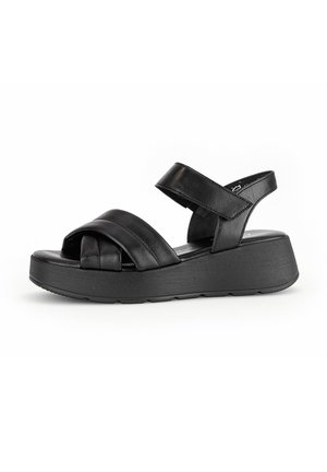 Zwarte leren sandalen met een ontwerp van gekruiste bandjes en een achterriem. Dikke plateauzool voor extra hoogte en comfort. Gladde textuur.