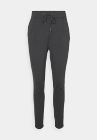 Mörkgrå joggerbyxor gjorda av mjukt, elastiskt material. Har en elastisk midja med snörning, sidofickor och avsmalnande ben.